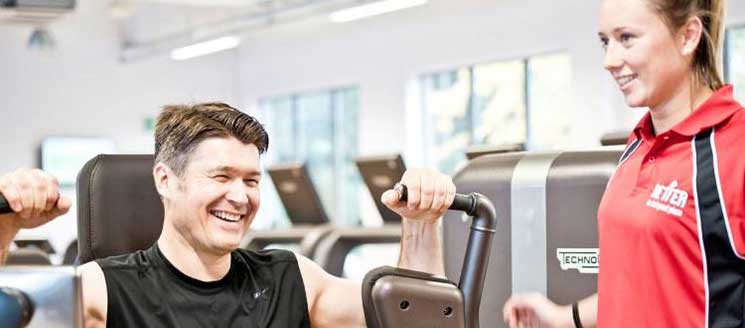 A man and a woman training in a gym